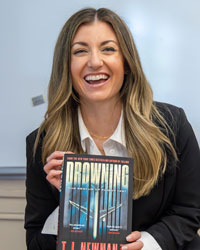 Torri TJ Newman holds her novel Drowning