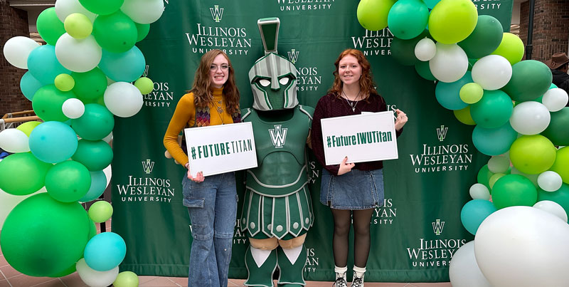 Two admitted students posing with Tommy Titan during Admitted Student Day