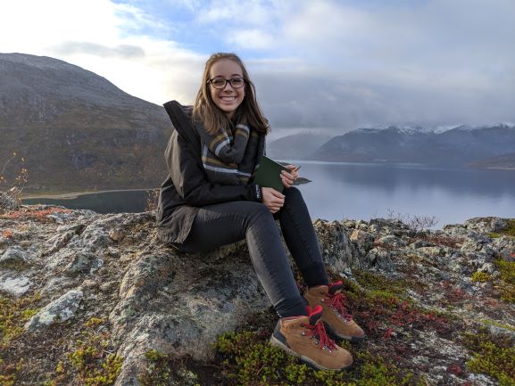 Emily Schirmacher, smiling to camera while posing for a photo during a hike