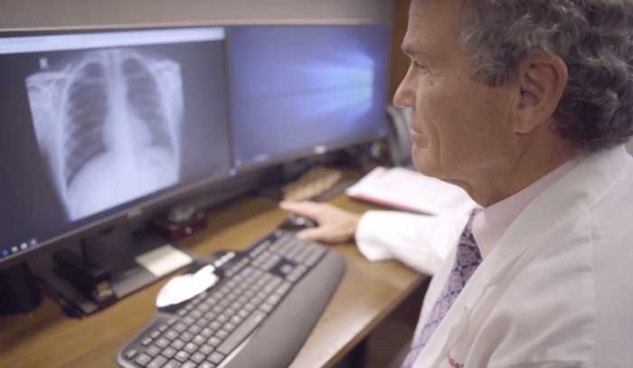 Farrar reviews an X-ray on the campus of The Ohio State University Wexner Medical Center. 