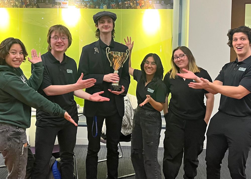 students on IWU ethics bowl team pose with trophy