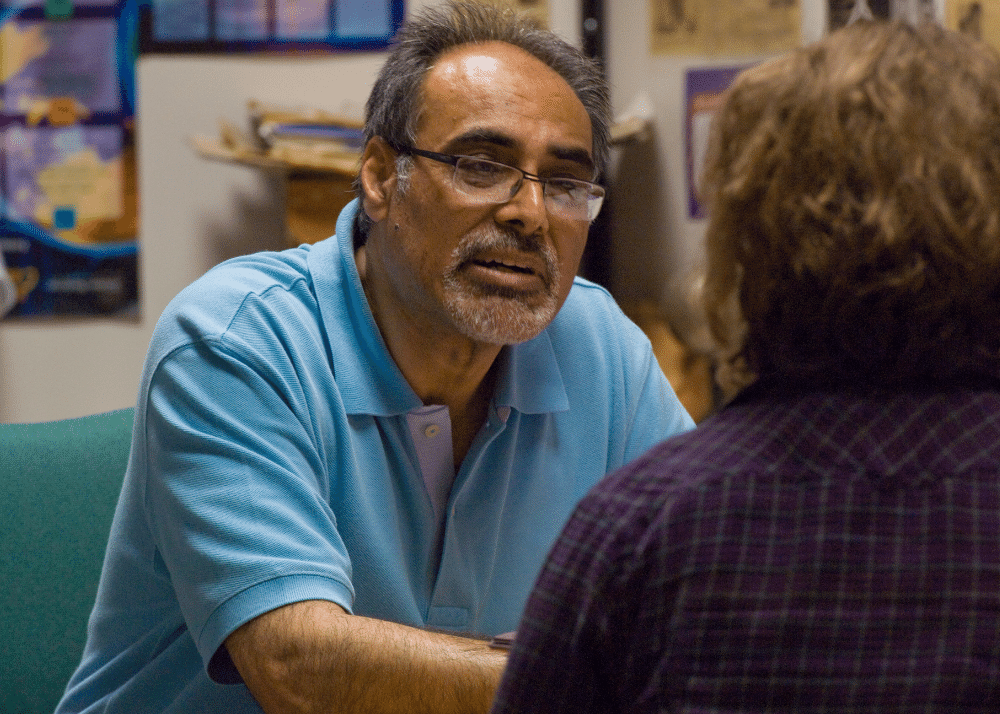 Professor Jaggi speaks with a student