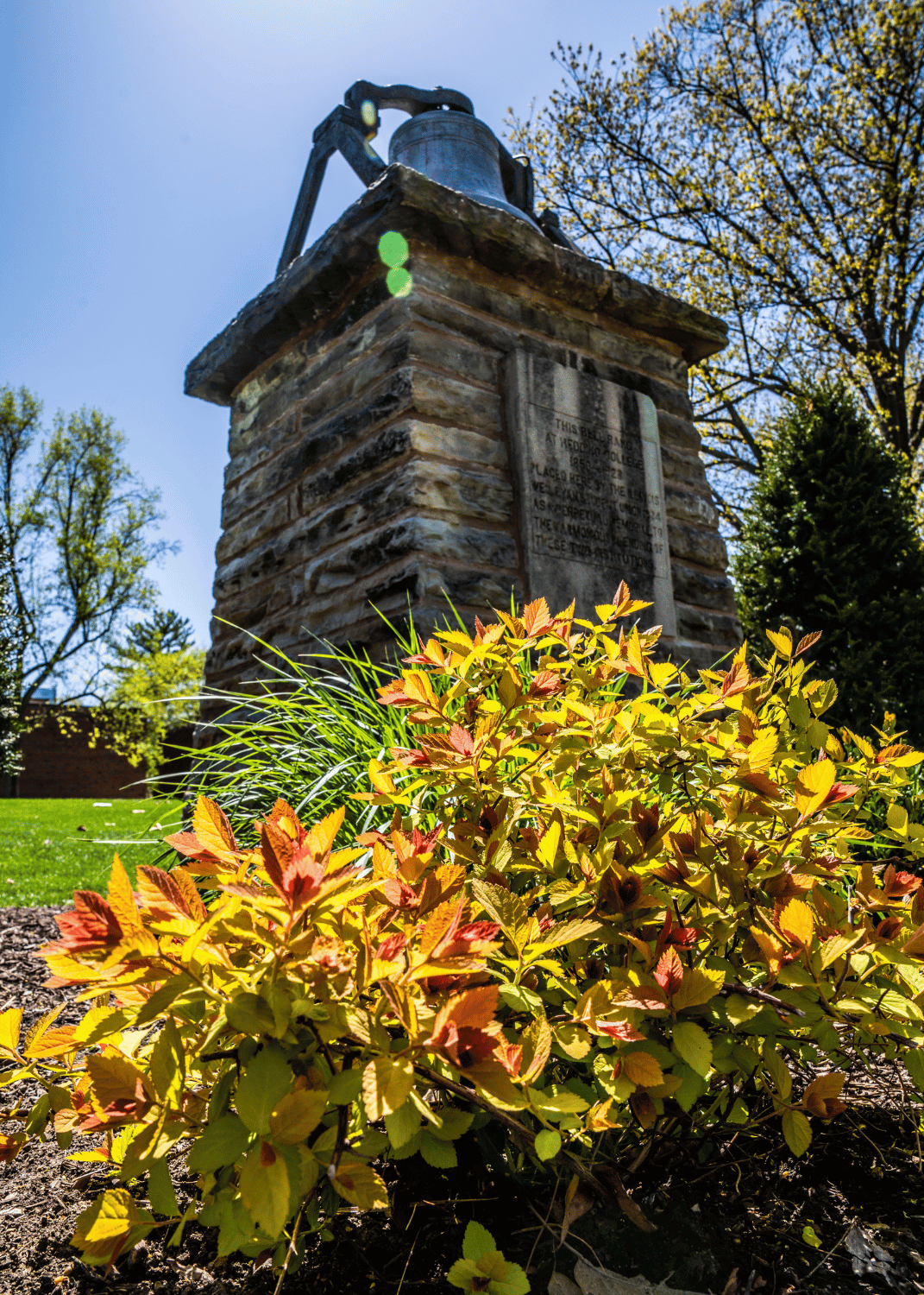 Bell on campus with sky behind