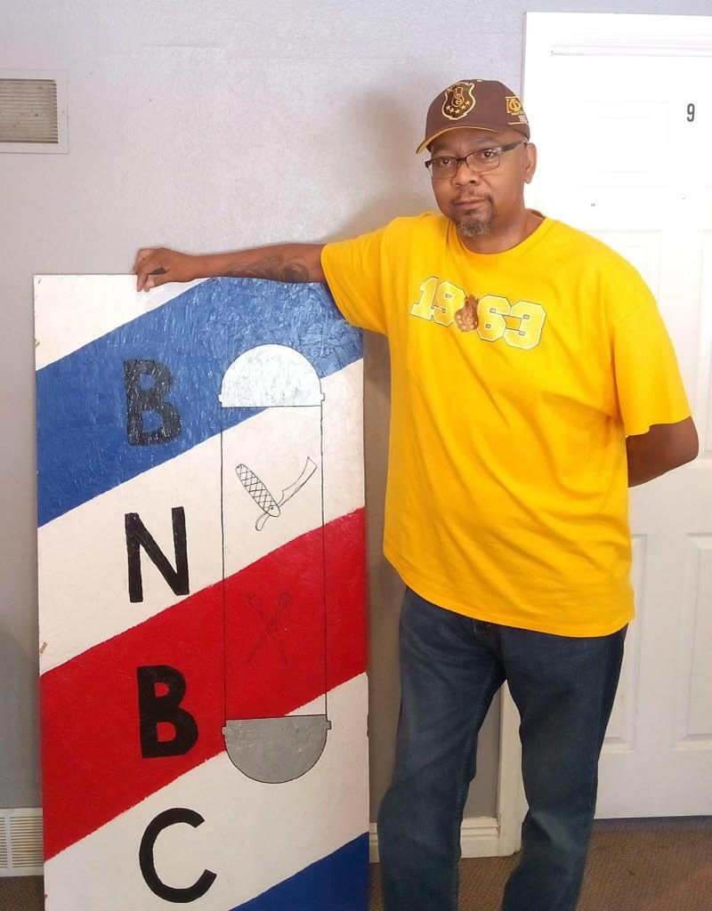 Cassius Crittendon with BN Barber College sign