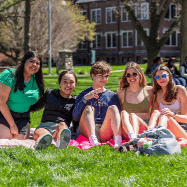 students sitting on blankets on the quad