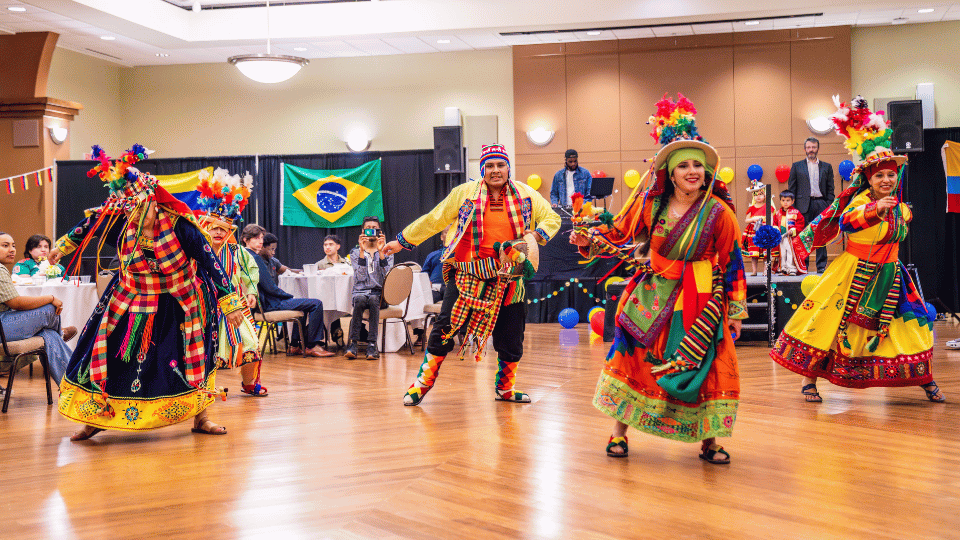 Barrio dancers in colorful clothing perform in Young Main Lounge in Spring 2024