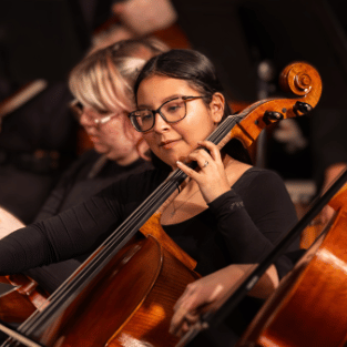 Student playing string instrument at IWU