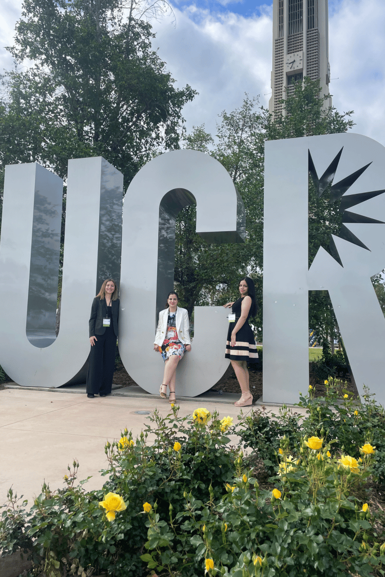 Three IWU students standing in front of University of California-Riverside sign