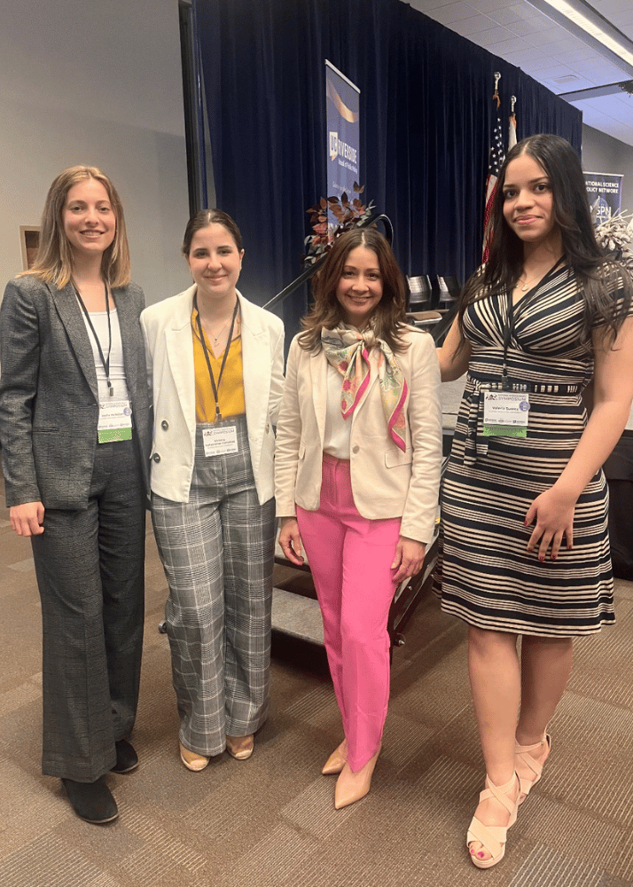 IWU students standing with keynote speaker at national science to policy symposium