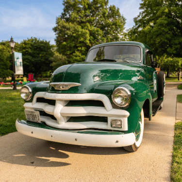 Green and white vintage truck on the quad