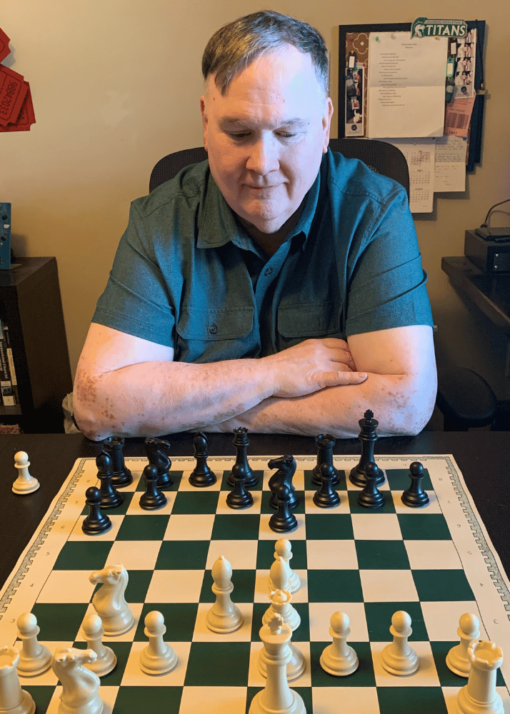 Robert Irons ponders over a chess board