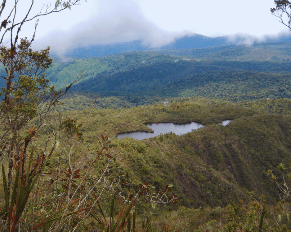 mountaintop view of a green valey with lake in remote region of Peru