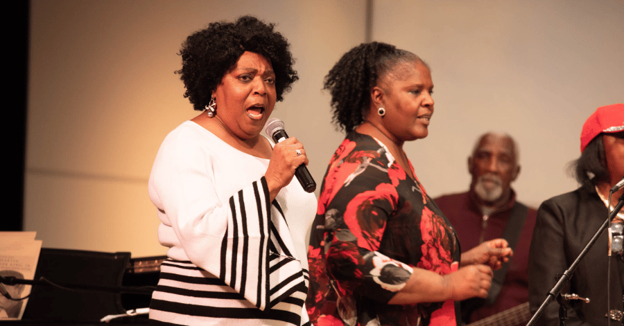 Women singing on stage at past Dr. Martin Luther King Jr. Gospel Festival at Illinois Wesleyan University