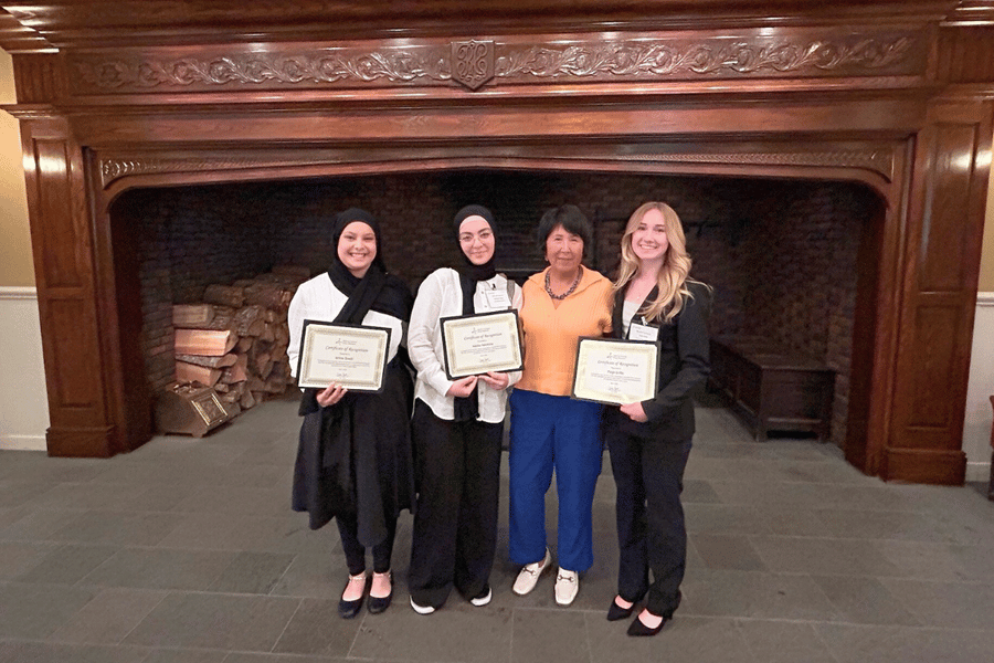Three IWU students with Washington State Re. Debra Lekanoff